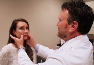 Dr. Robert Houser performs an exam on Kim Comisar following lip implant surgery. According to new data from the American Society of Plastic Surgeons, a record number of patients underwent lip implant surgery in 2015.
