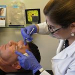 Dr. Anne Taylor gives a patient Botox injections in her Columbus, Ohio office. New statistics from the American Society of Plastic Surgeons reveals that minimally invasive procedures have risen more than 75% among men since 2000.